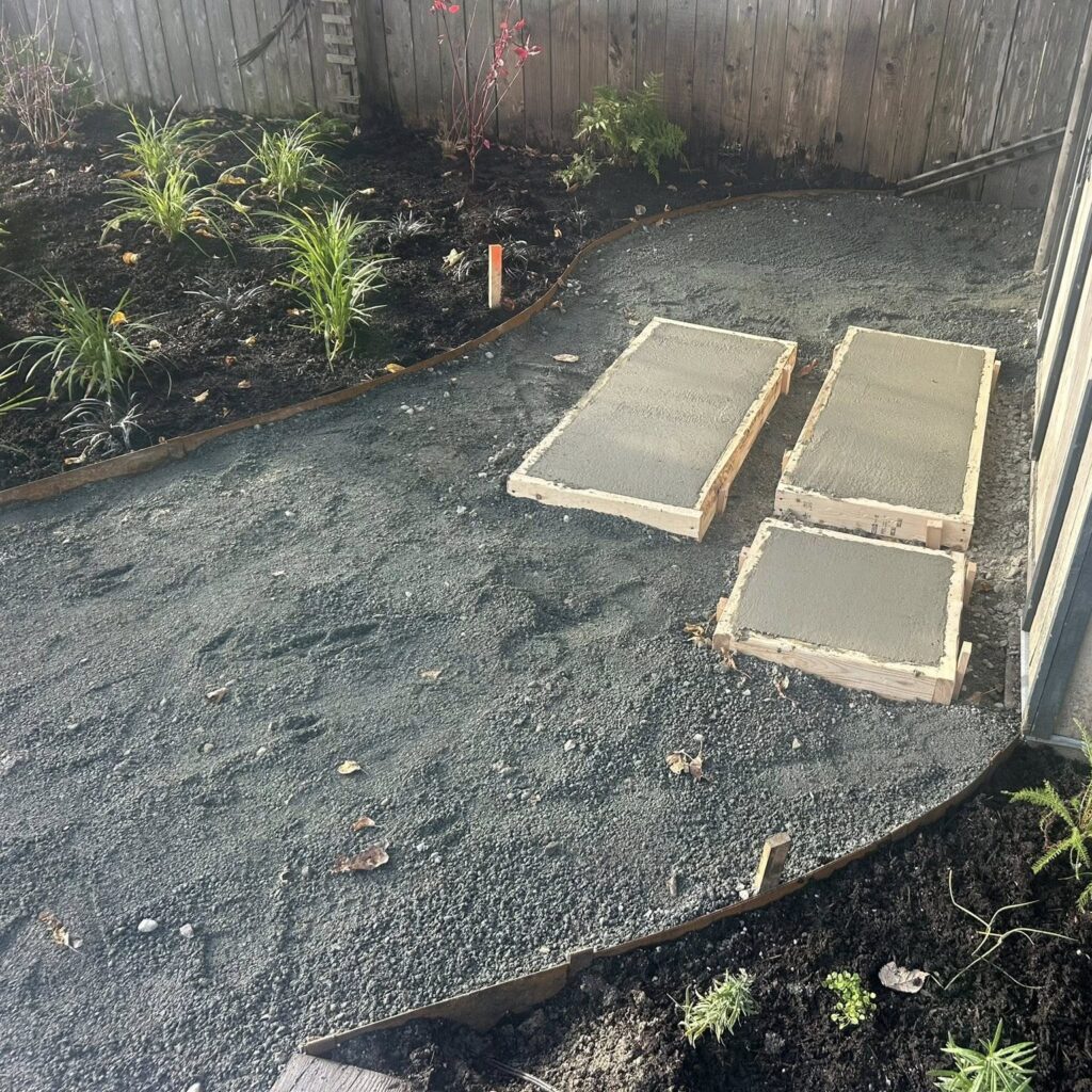 Freshly poured concrete slabs in garden patio project by CBS Masonry
